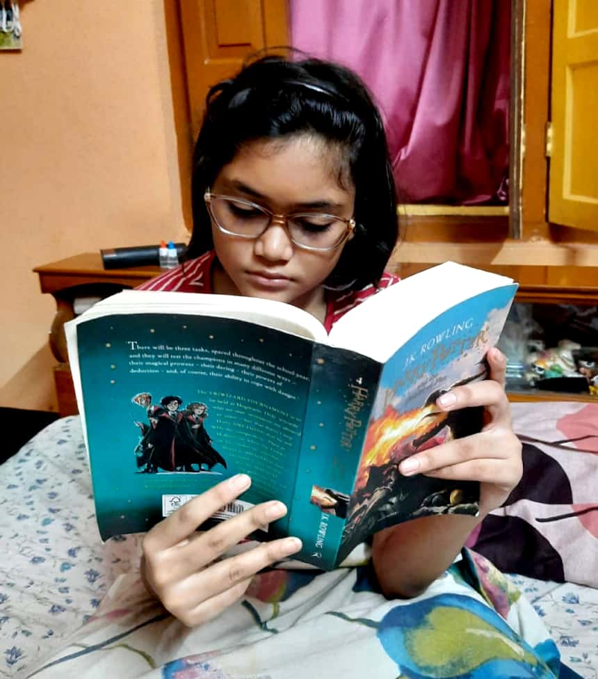 Gen Z Readers Return to Print and Libraries, Nationwide Data 1 A teenage girl reading Harry Potter and the Goblet of Fire